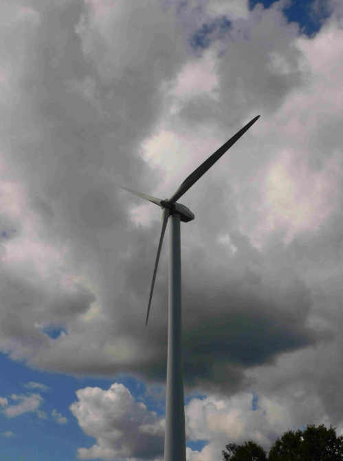 Wind turbine peaking out of the clouds.